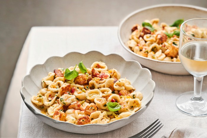 Two plates of orecchiette with halloumi