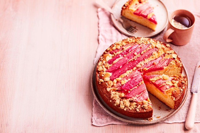 A rhubarb cake with one slice taken out of it