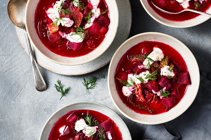 Four bowls of beetroot borscht