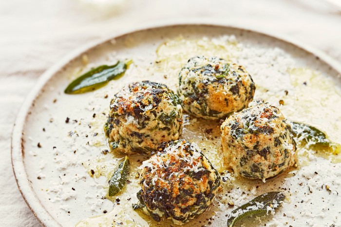 Four spinach gnudi on a plate