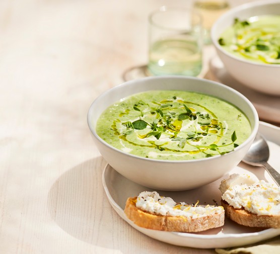 Pea and Mint Soup in a Bowl with Small Ricotta Toasts