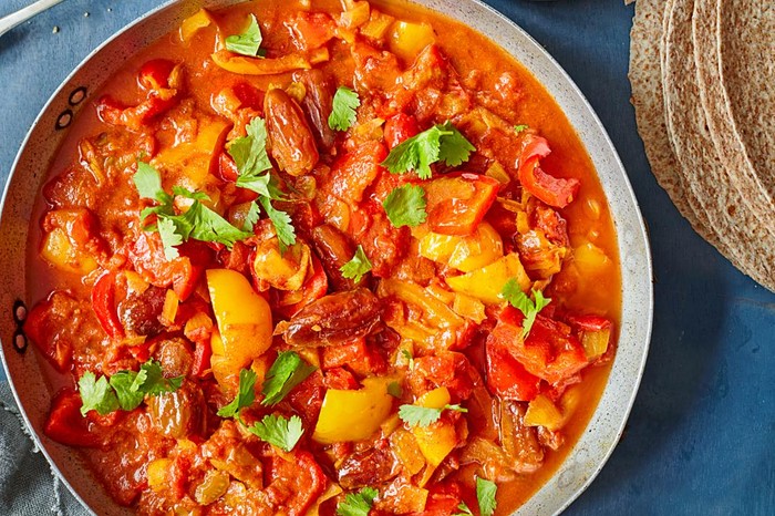 11 easy healthy slow cooker recipes Pepper, date and harissa tagine in a serving bowl