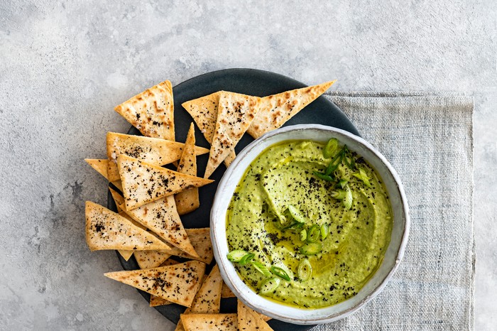 Bowl of Pea Hummus with Toasted Pitta Triangles