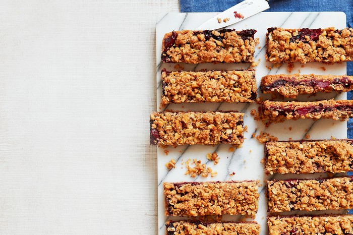 A marble chopping board topped with slices of oaty bars