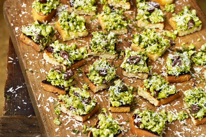 Small bruschetta squares on a wooden board