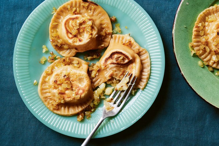 Two plates of three Polish pierogi