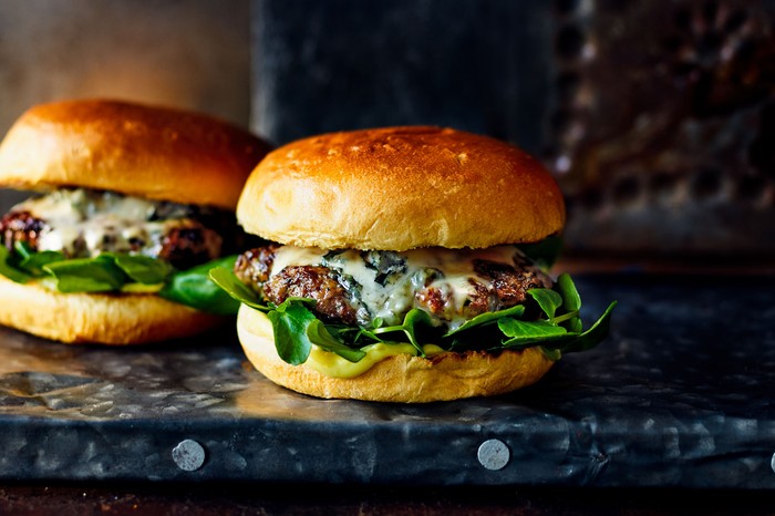 Two venison burgers in buns with lettuce