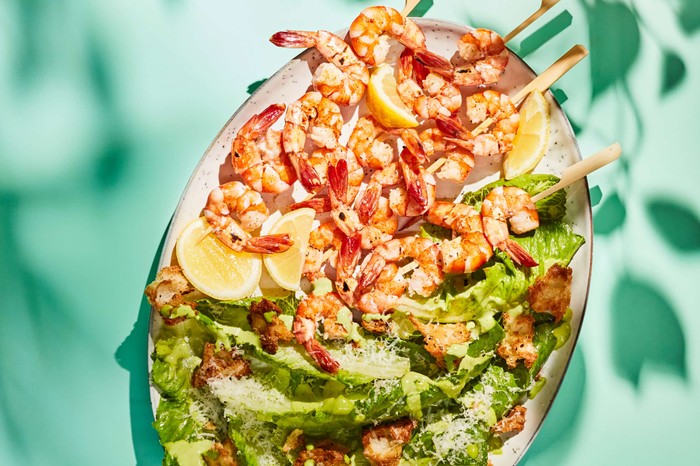 Prawn caesar salad on an oval platter