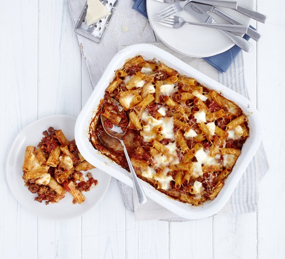 A baked rigatoni dish with tomatoes and sausages