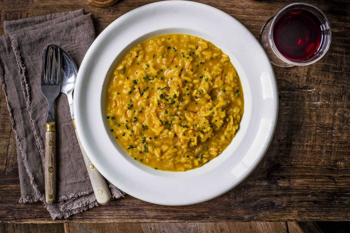 Saffron risotto An aerial shot of saffron-coloured risotto on a white plate
