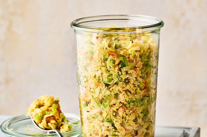 Tall glass container filled with sauerkraut