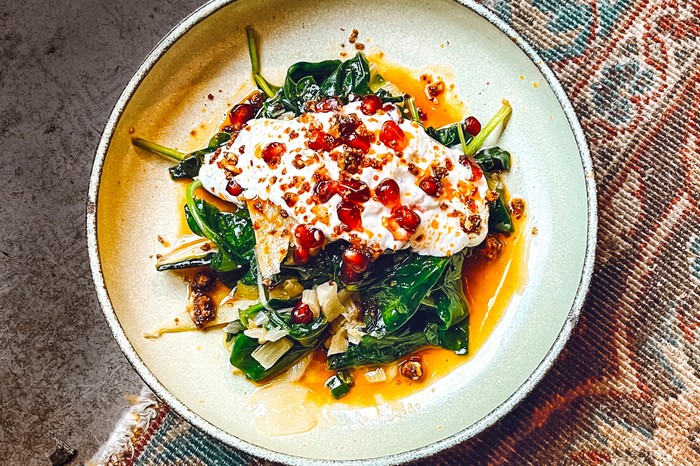 Sauteed greens A plate of greens topped with Greek yogurt and pomegranate seeds