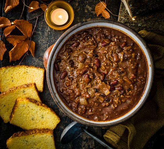 A large pot of slow-Cooker beef chilli, served with Jalapeño cheddar cornbread