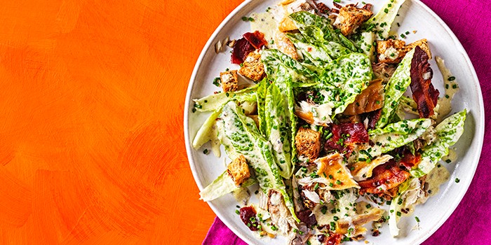 Smoked Mackerel Caesar Salad on an Orange Background