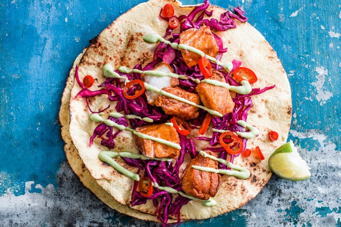 Gently spiced Baja cod fish tacos served with pickled chillies, purple slaw and homemade avocado crema dressing