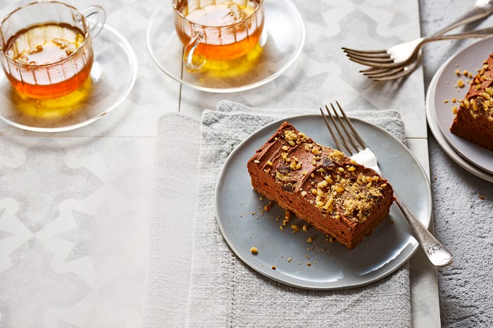 A chocolate cheesecake bar on a small plate