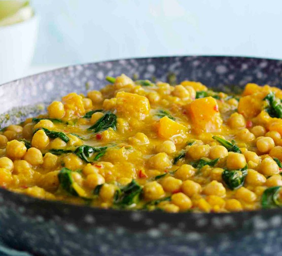 Butternut squash and chickpea curry in a blue frying pan