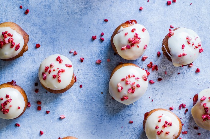 Small doughnuts topped with white chocolate and freeze-fried stawberries