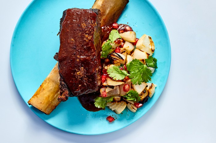 Ribs and salad on a blue plate