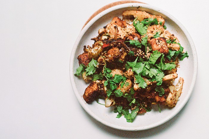 Vegan stir-fry A white plate with a tofu stir-fry on it, topped with coriander