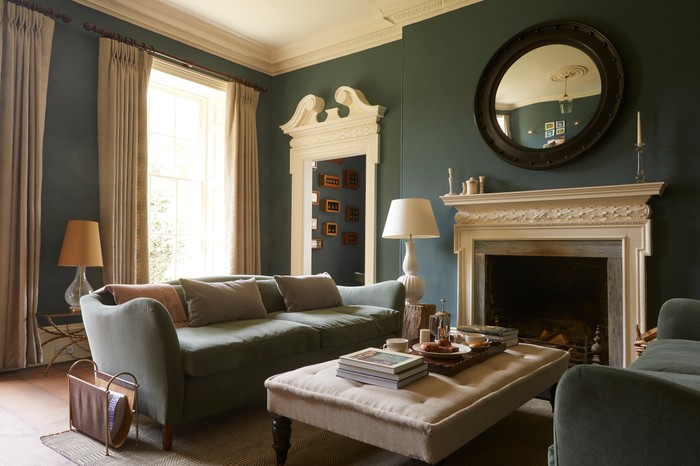 Sofas and a coffee table by a fire in The Rectory Hotel Sitting Room