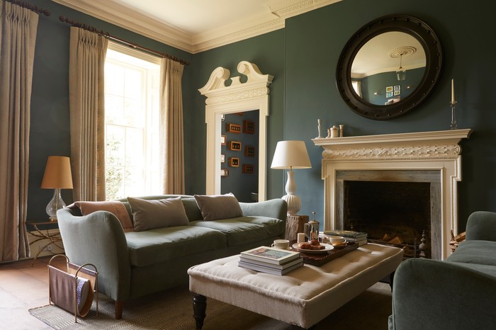 The Rectory Hotel Sitting Room Sofas and a coffee table by a fire in The Rectory Hotel Sitting Room