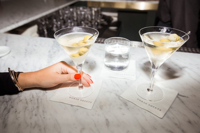 Two glasses of martini on a marble counter at Three Sheets Soho