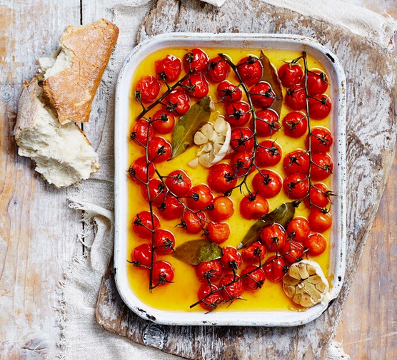 Roasted cherry tomatoes on the vine, on a plate