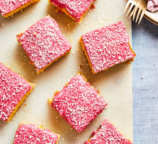 Squares of pink Tottenham cake on a board