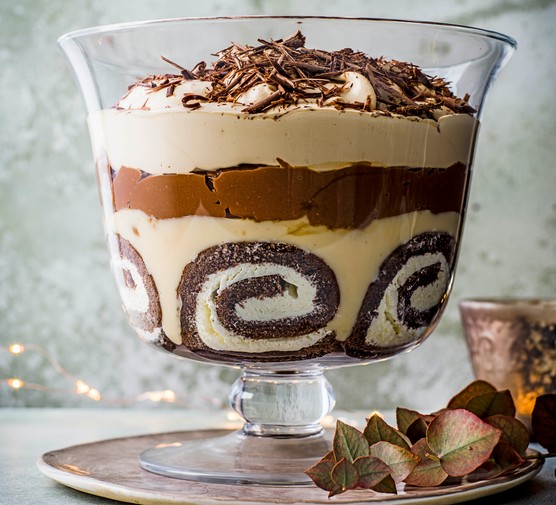 Multi-layered chocolate and Baileys cream trifle in a glass bowl