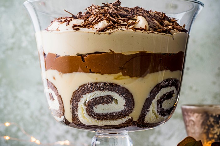 Multi-layered chocolate and Baileys cream trifle in a glass bowl