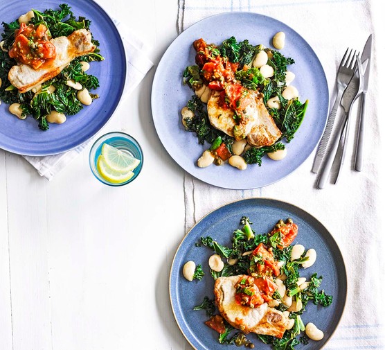 Tuscan pork loin steaks Tuscan pork loin steaks with butterbeans and greens on plates