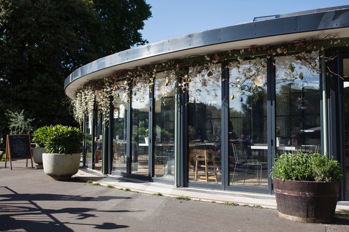 The round glass building home to Pear Tree Cafe sits next to the river in Battersea park