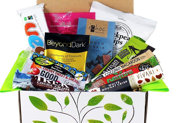 A white box filled with bars of chocolate and packets of snacks