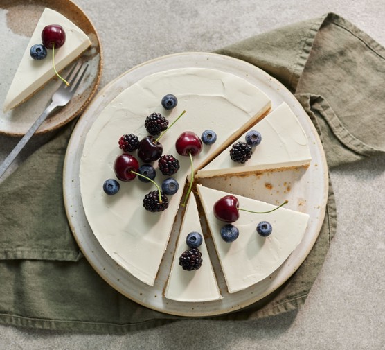 Vegan vanilla cheesecake topped with berries and cherries