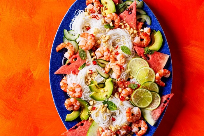 Oval platter filled with watermelon, prawns and noodles