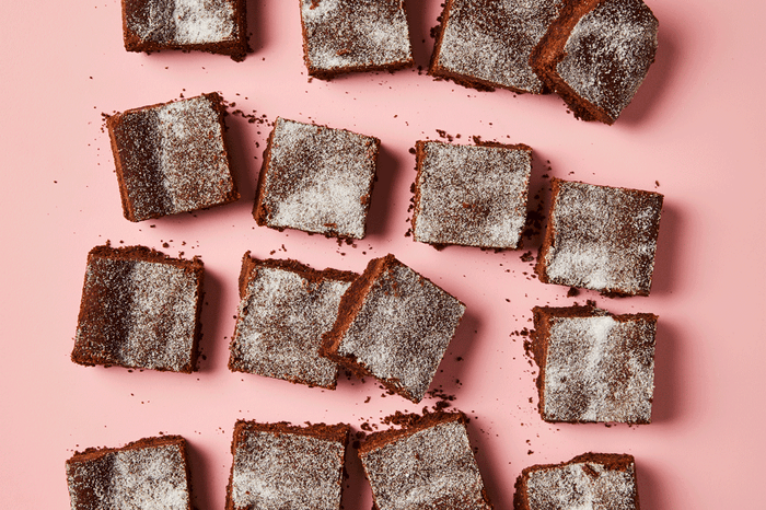 Squares of chocolate concrete cake on a pink background