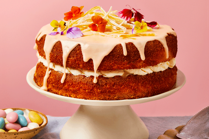 Lemon and elderflower layer cake topped with icing and edible flowers