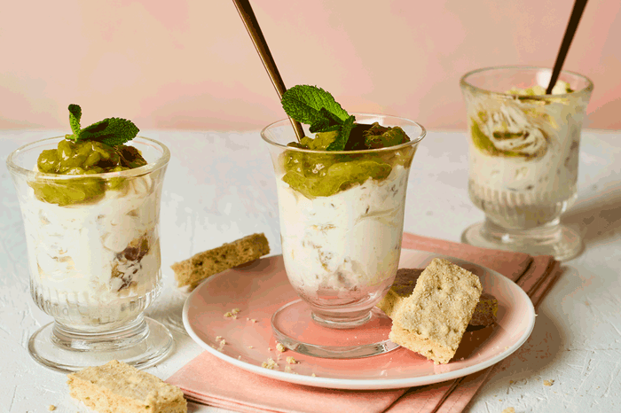 Three gooseberry, elderflower and mint fools in glass jars