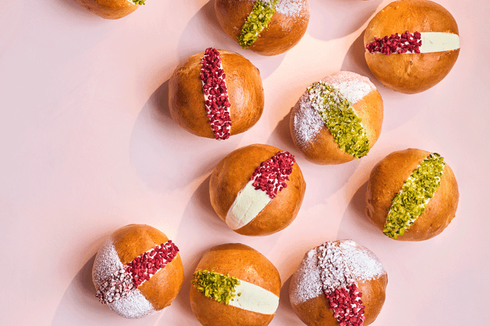 Italian maritozzi buns filled with lemon and elderflower and topped with crushed pistachios and raspberries