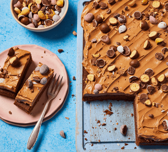 Malted milk chocolate traybake with a slice taken out