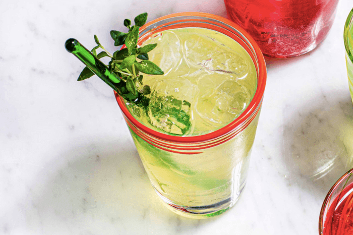 Limoncello spritz with a thyme sprig garnish