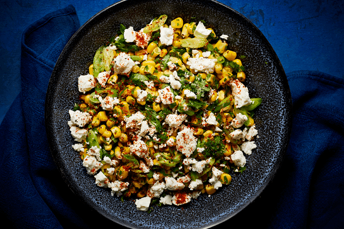 Bowl of salad with sweetcorn, feta and lime