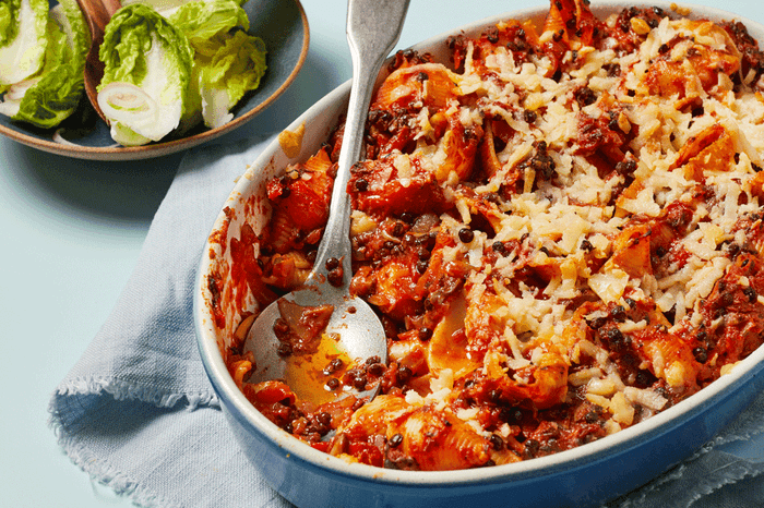 Vegan pasta bake in a baking dish with salad on the side