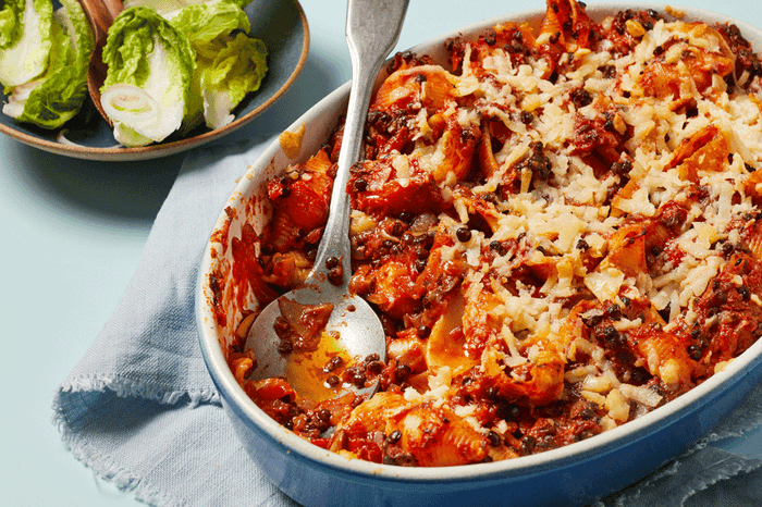 Vegan pasta bake in a baking dish with salad on the side